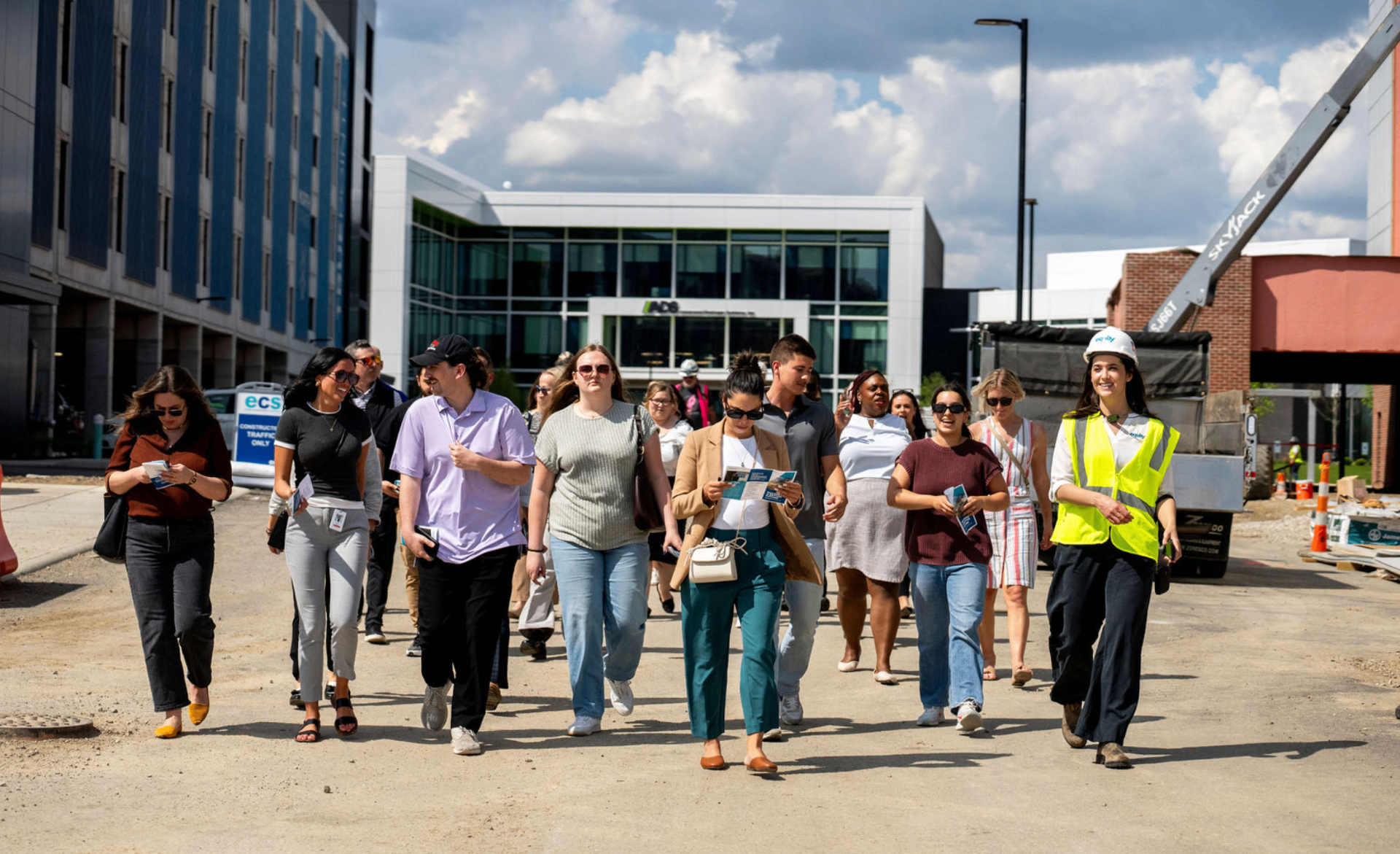 Hard-hat site tour with brokers and partners walking the development